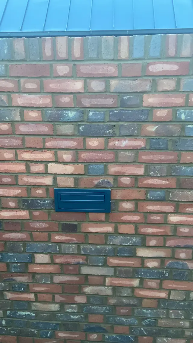New brick wall built from reclaimed-style mixed bricks