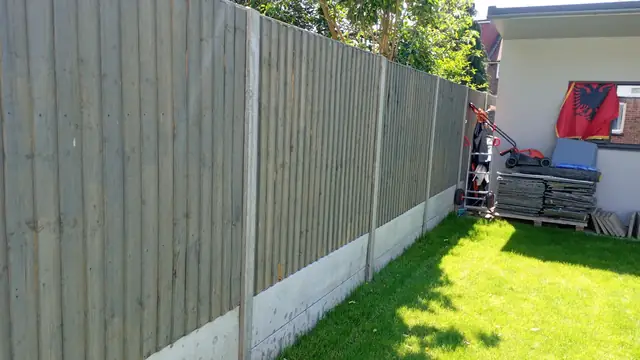 Run of new closeboard fence panels on concrete gravel boards
